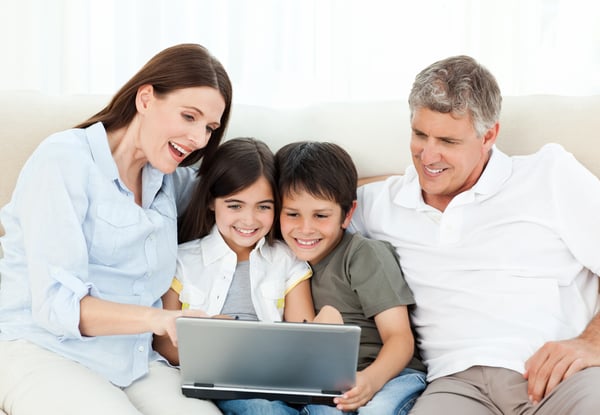 Family looking at the laptop at home